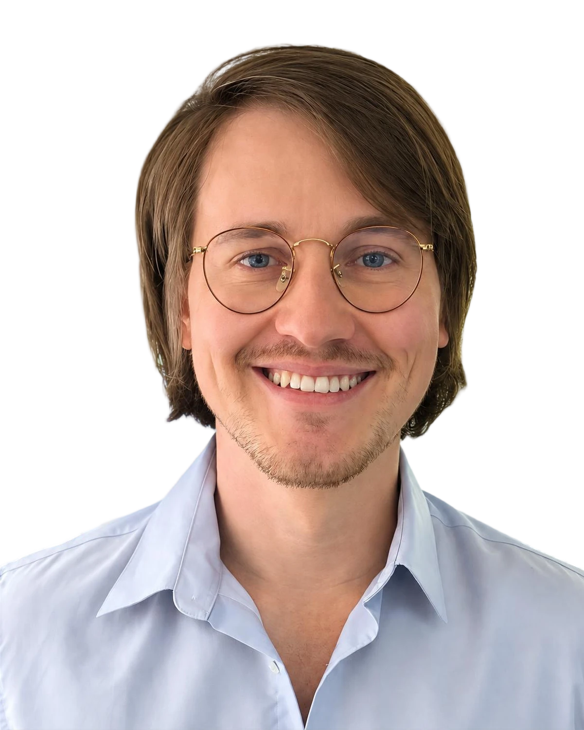 Virgil Dubois smiling, in round gold-rimmed glasses and a light blue shirt.